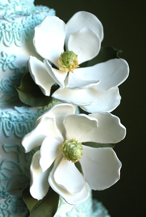 5 tier wedding cake with blue piping and gumpaste magnolias detail