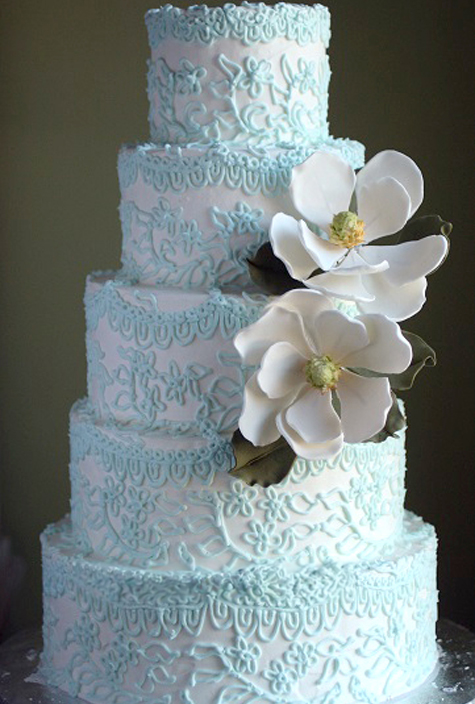 5 tier wedding cake with blue piping and gumpaste magnolias