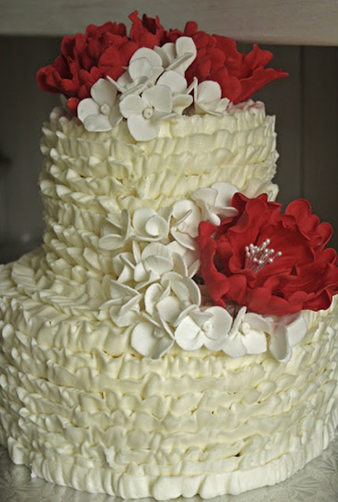 buttercream ruffle cake with red and white gumpaste flowers