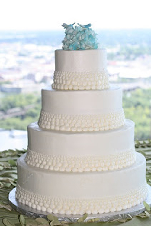 dots wedding cake with blue gumpaste hydrangeas and dragonflies