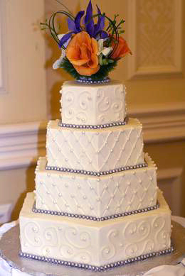 hexagonal cake with fondant pearls and fresh flowers