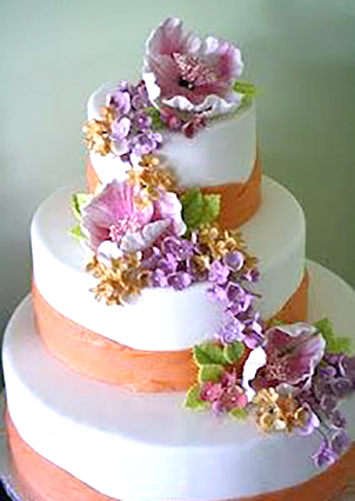 orange bands and gumpaste flower cascade wedding cake