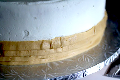 piped buttercream strip on a cake