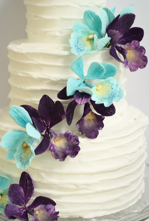 rustic icing wedding cake with blue and purple gumpaste orchids
