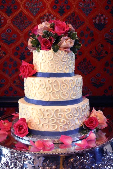 scrollwork cake with fresh flowers