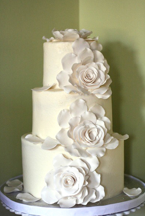 small three tiered wedding cake with three gumpaste exploded roses