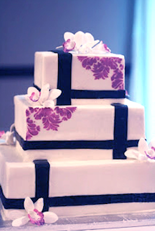 stenciled black and white cake with pink design and gumpaste flowers