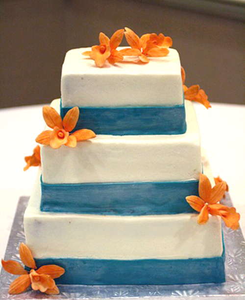 teal bands with orange orchides square wedding cake