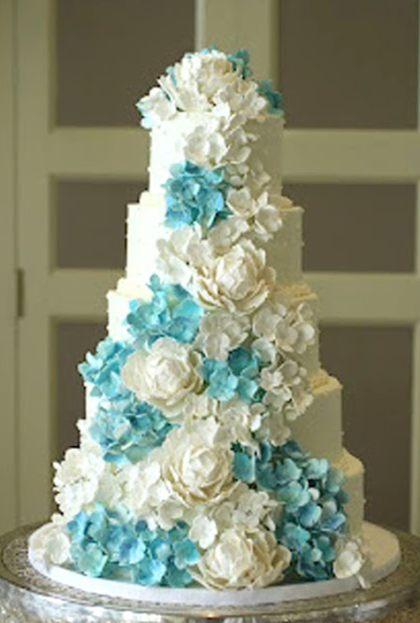 wedding cake with blue and white gumpaste hydrangeas and white peonies