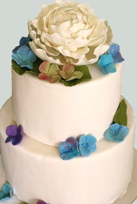 wedding cake with white and blue gumpaste flowers
