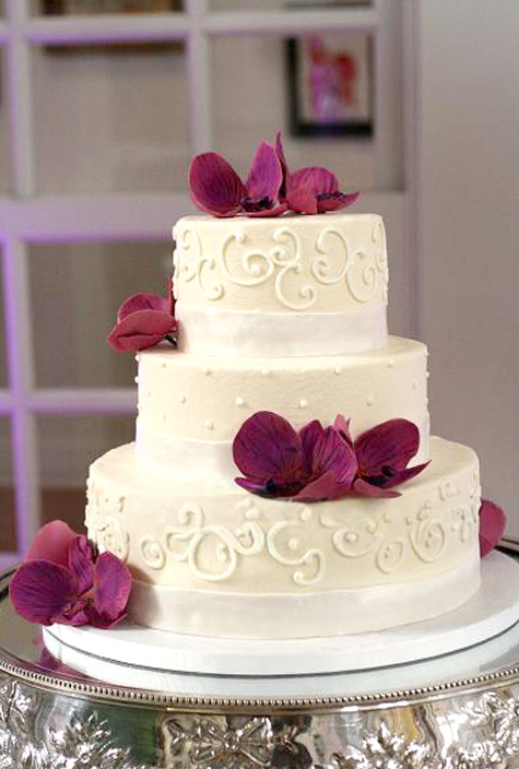 white piped cake with gumpaste orchids