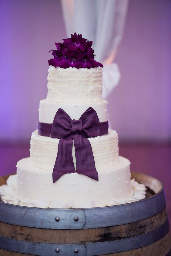 purple bos wedding cake with fresh flowers topper