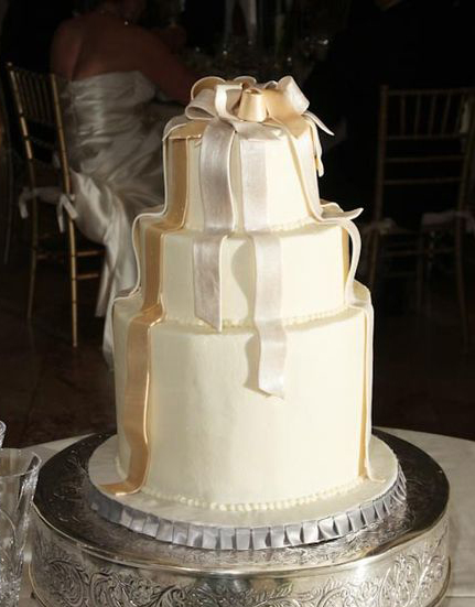 white cake with metallic ribbons