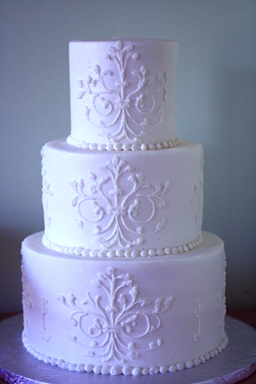 small wedding cake with white piping