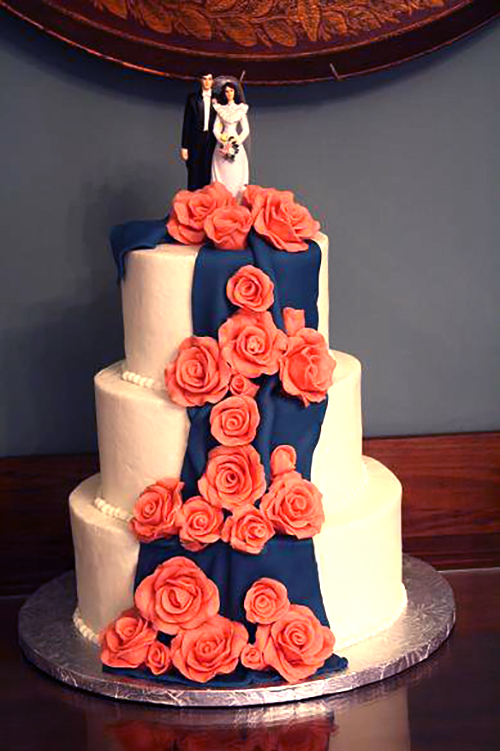 blue drape cake with pink chocolate roses