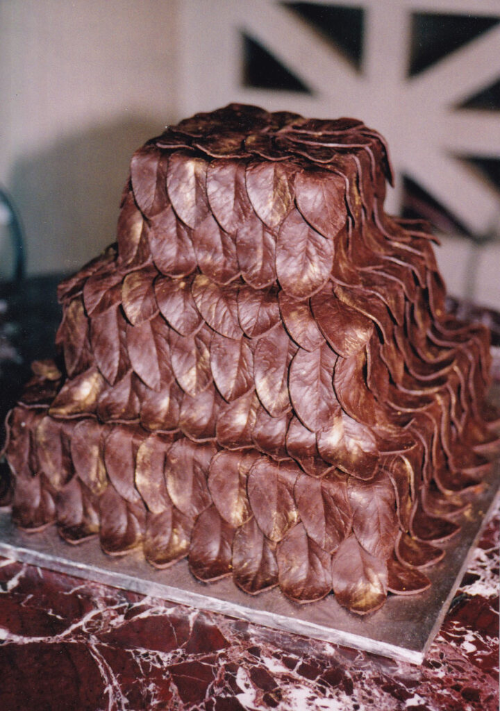 chocolate leaves cake with gold accents square tiers