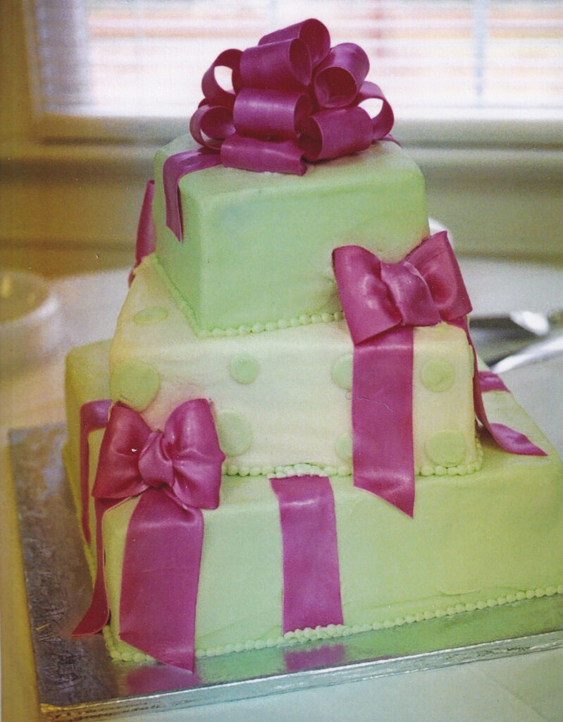 green square wedding cake with pink gumpaste bows