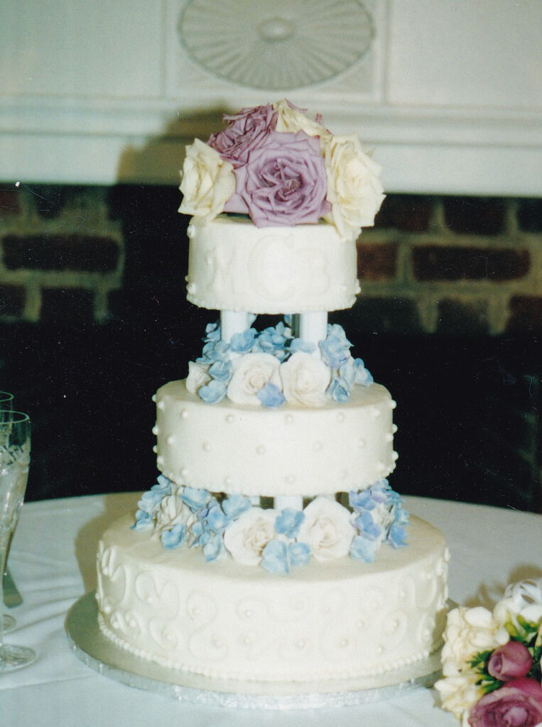 pearls and swirls wedding cake with pillars and gumpaste and fresh flowers