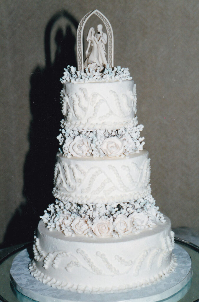 pillars wedding cake with piped lily of the valley and royal icing flowers