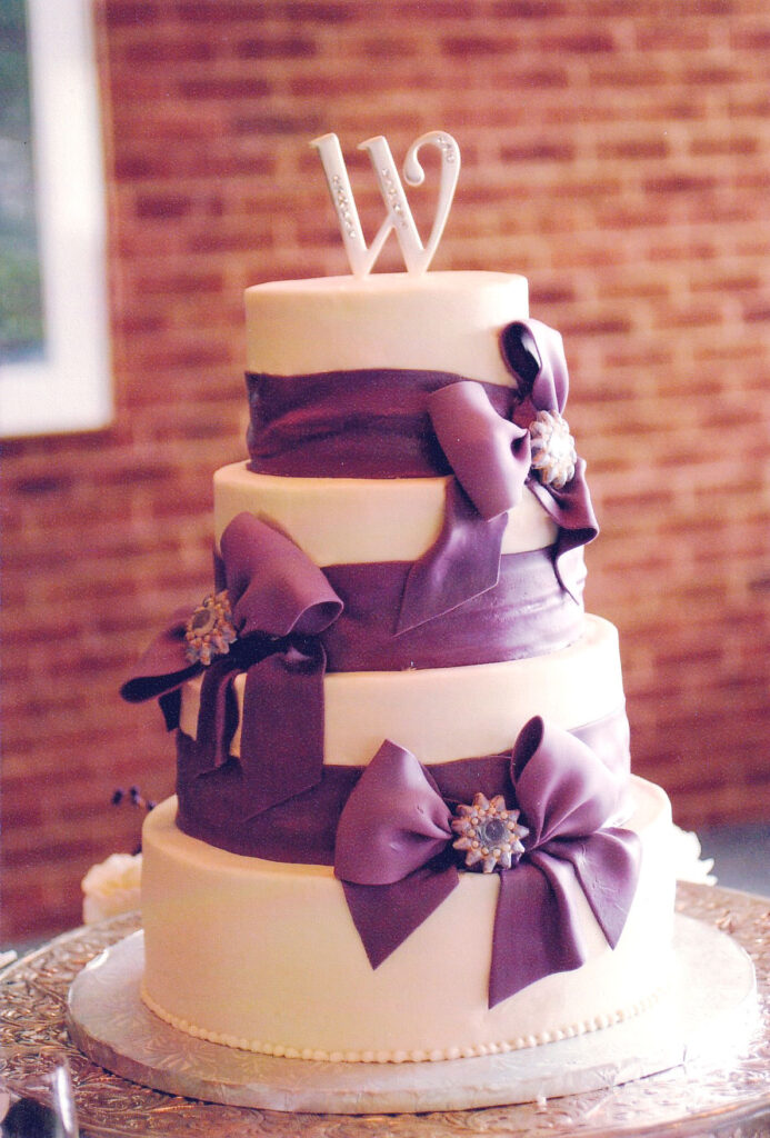 purple bows and gumpaste brooches wedding cake