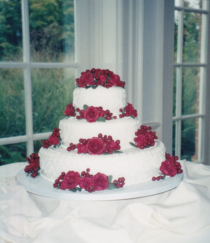 red roses and berries wedding cake with fondant lace overlays