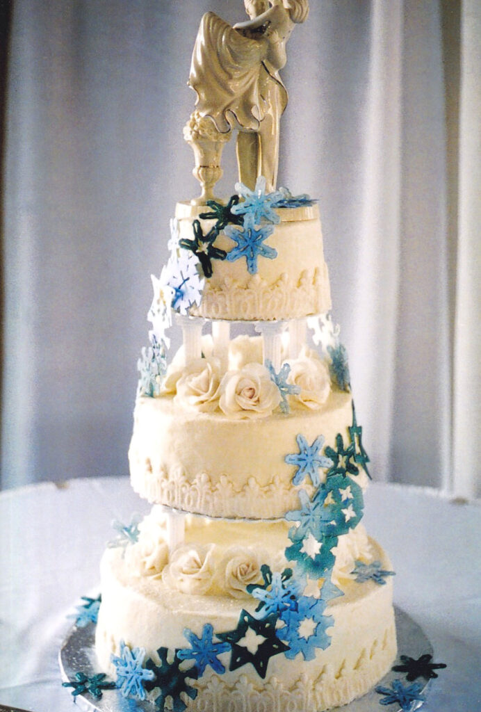 snowflake wedding cake with cascade of blue and white snowflakes
