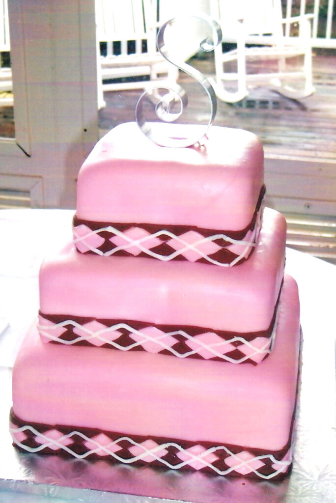 square pink wedding cake with chocolate argyle bands