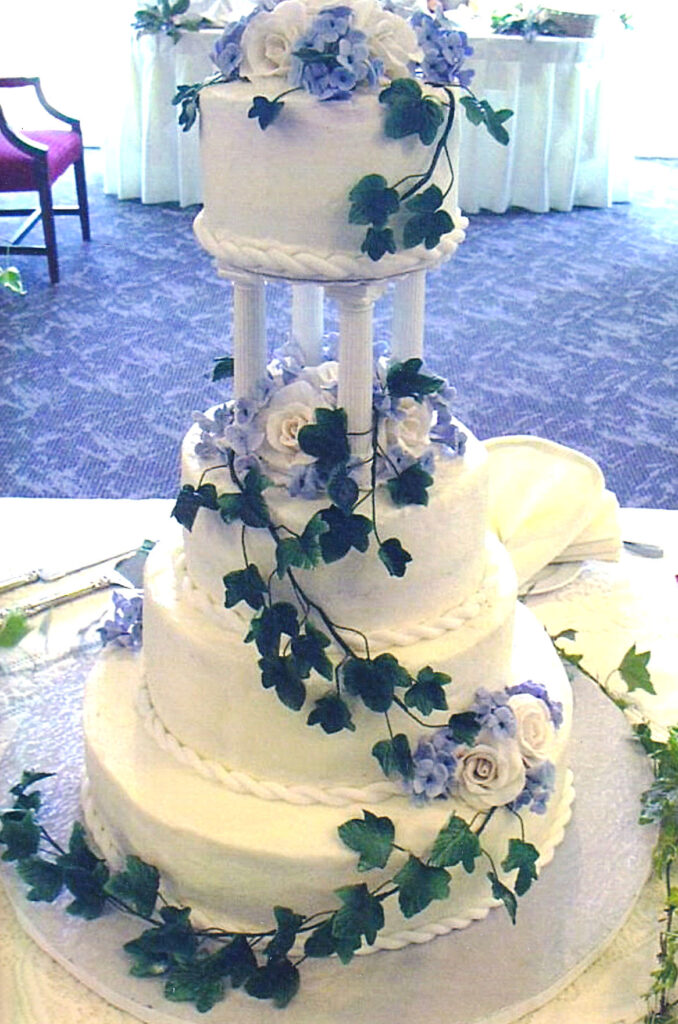 tall pillars wedding cake with white gumpaste roses and green gumpaste ivy