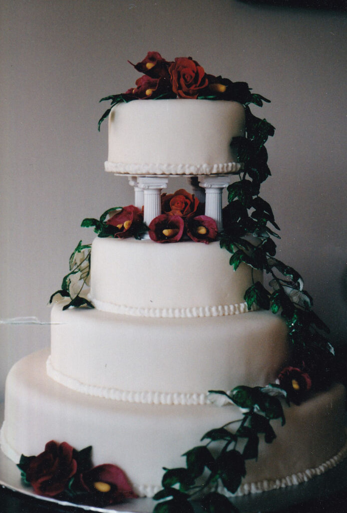 white wedding cake with burgundy callas and green gumpaste ivy