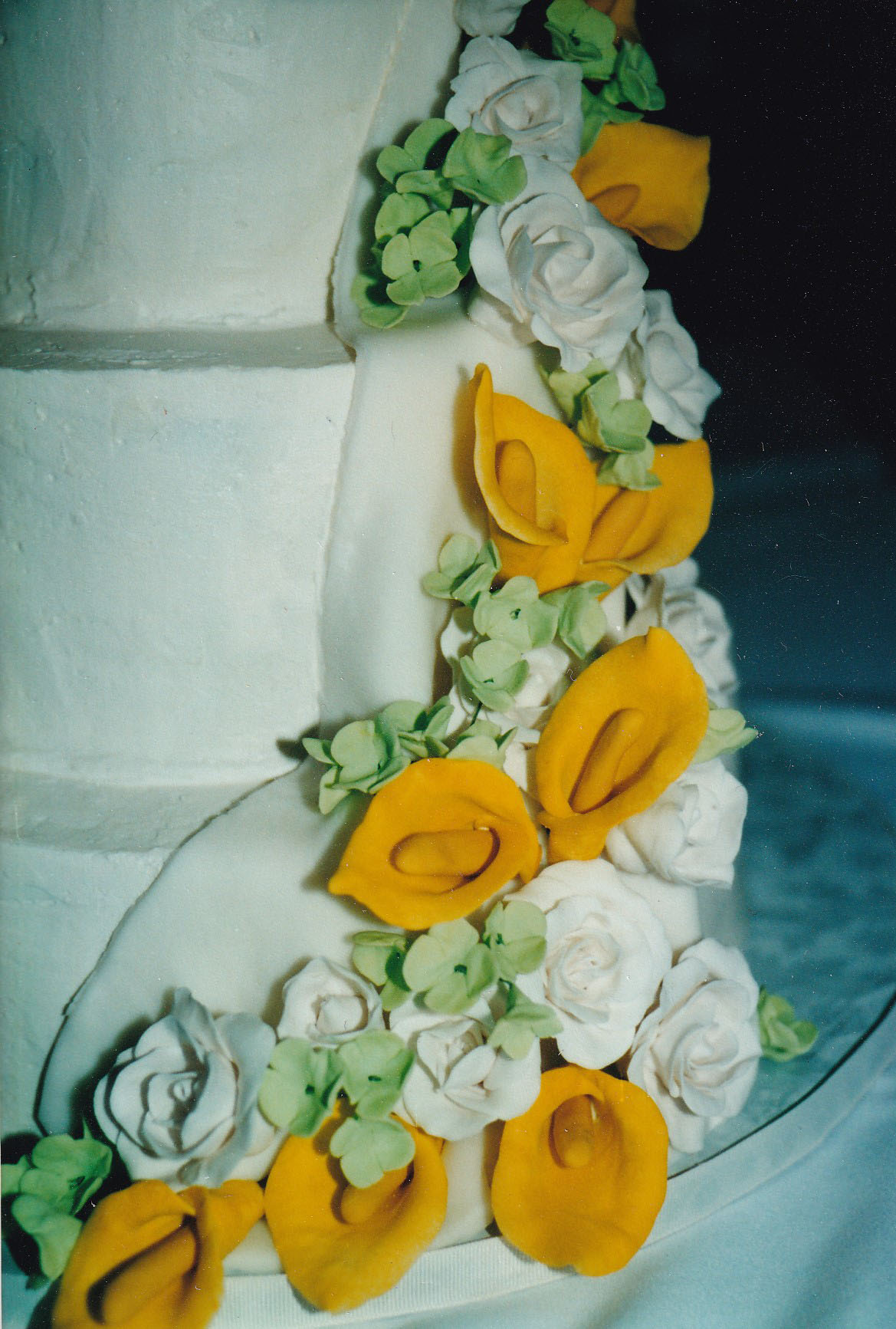 wedding cake with yellow and white callas and green gumpaste hydrangeas