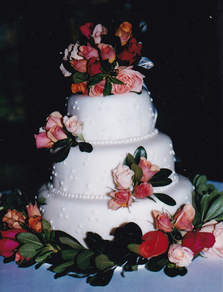 white swiss dots wedding cake with fresh flowers