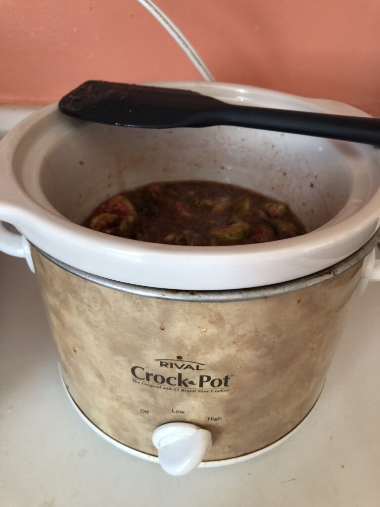 crock pot with mased up fruit inside