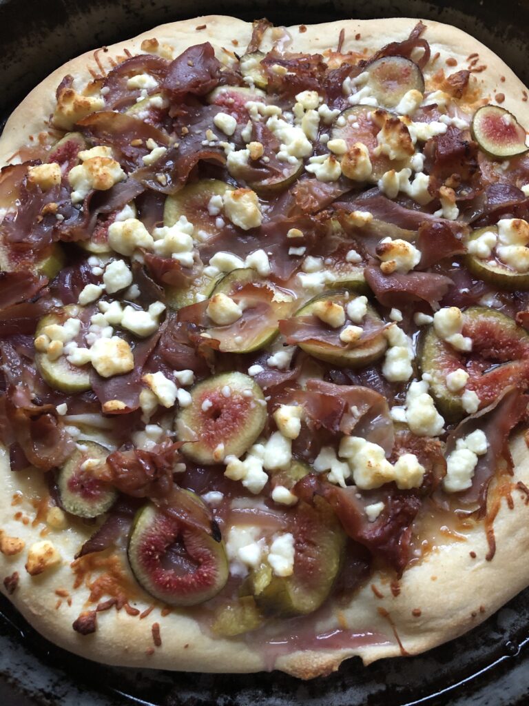 baked pizza with feta, figs, prosciutto and onions