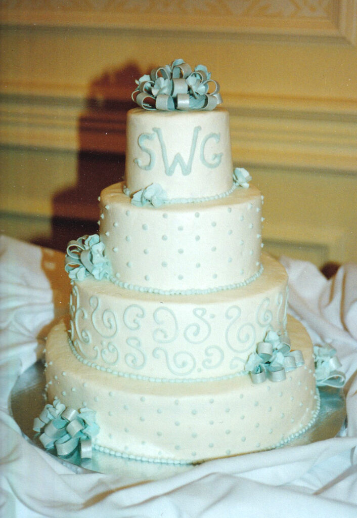 blue bows and monogram wedding cake with swirls