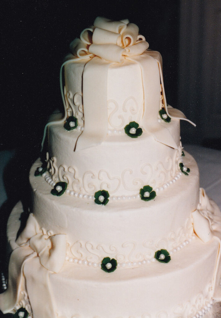 ivory fondant bows and green flowers wedding cake