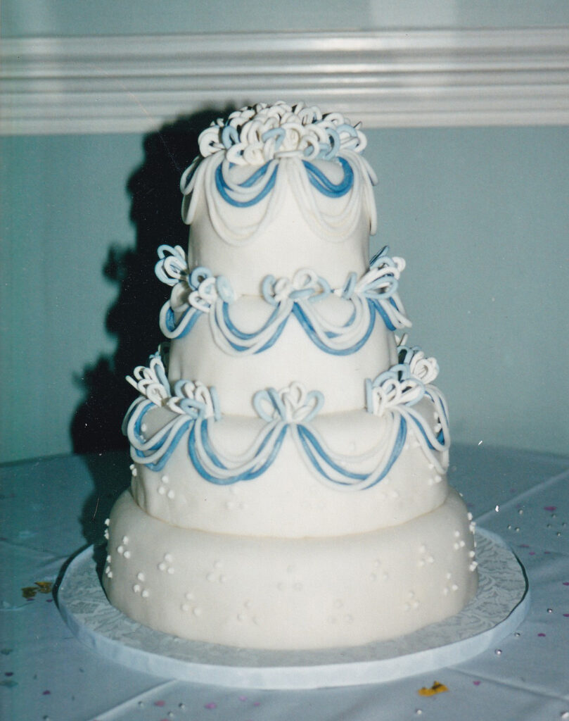 loopy blue and white drapes bows wedding cake