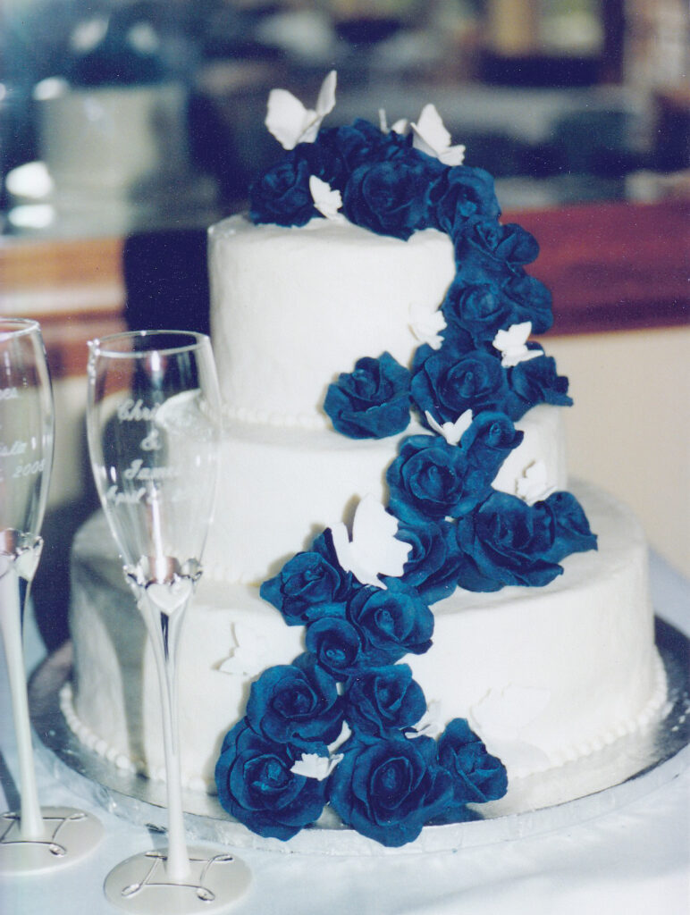 white wedding cake with blue chocolate roses