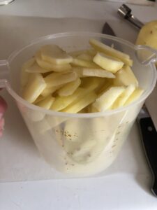 sliced apples in a measuring cup