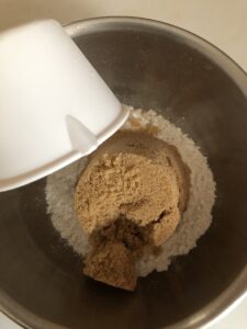 adding the sugar to the flour