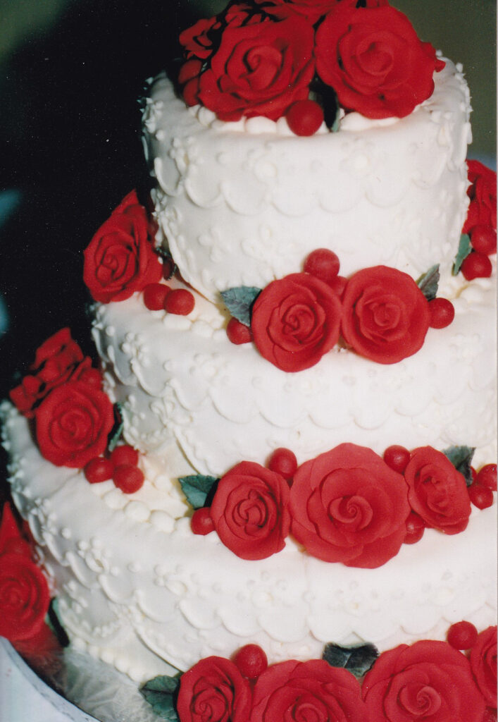 red roses and lace overlays wedding cake
