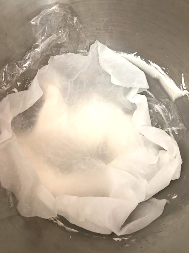 wet paper towel over the royal icing mixing bowl