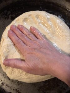 Pressing the dough out in the pan