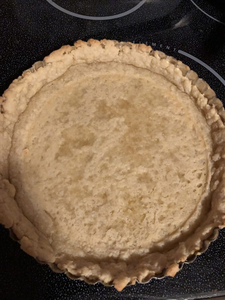 take the crust out of the oven and prick small holes in the crust but don't go all the way through if the filling is liquid