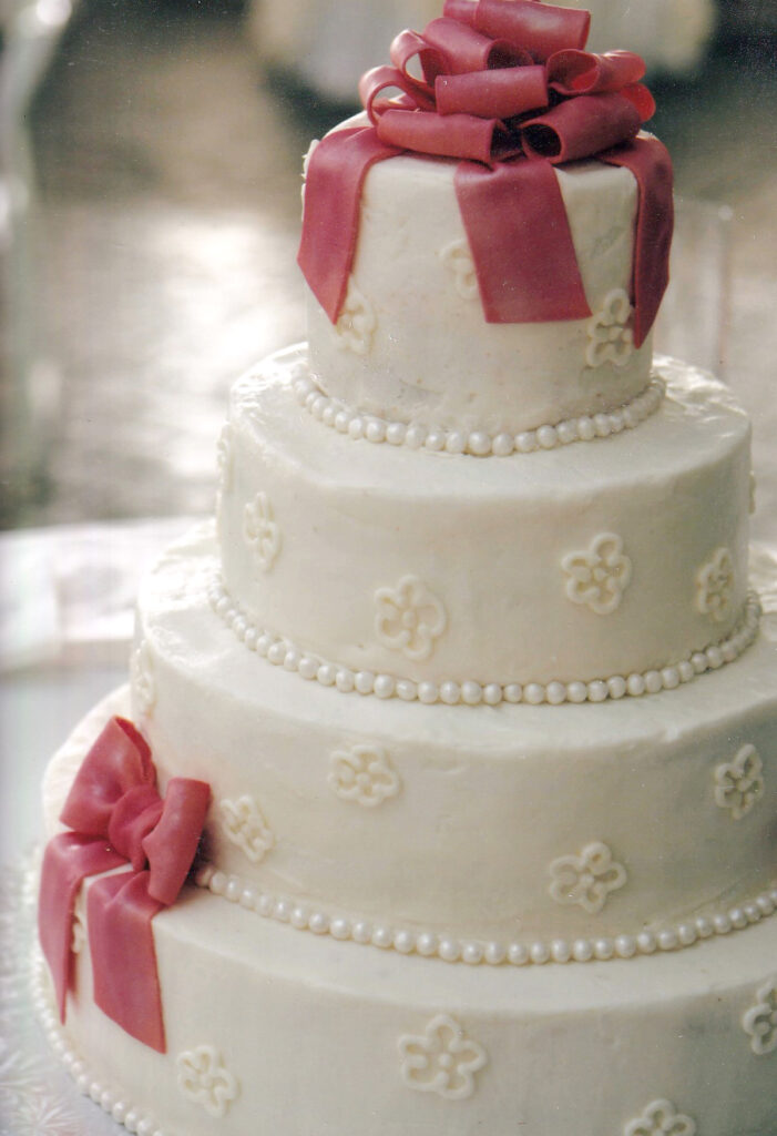 peach bows and fondant pearls wedding cake