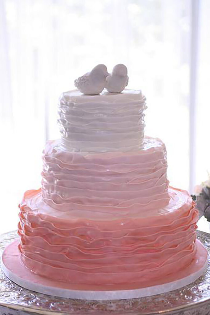pink ombre wedding cake with bird topper