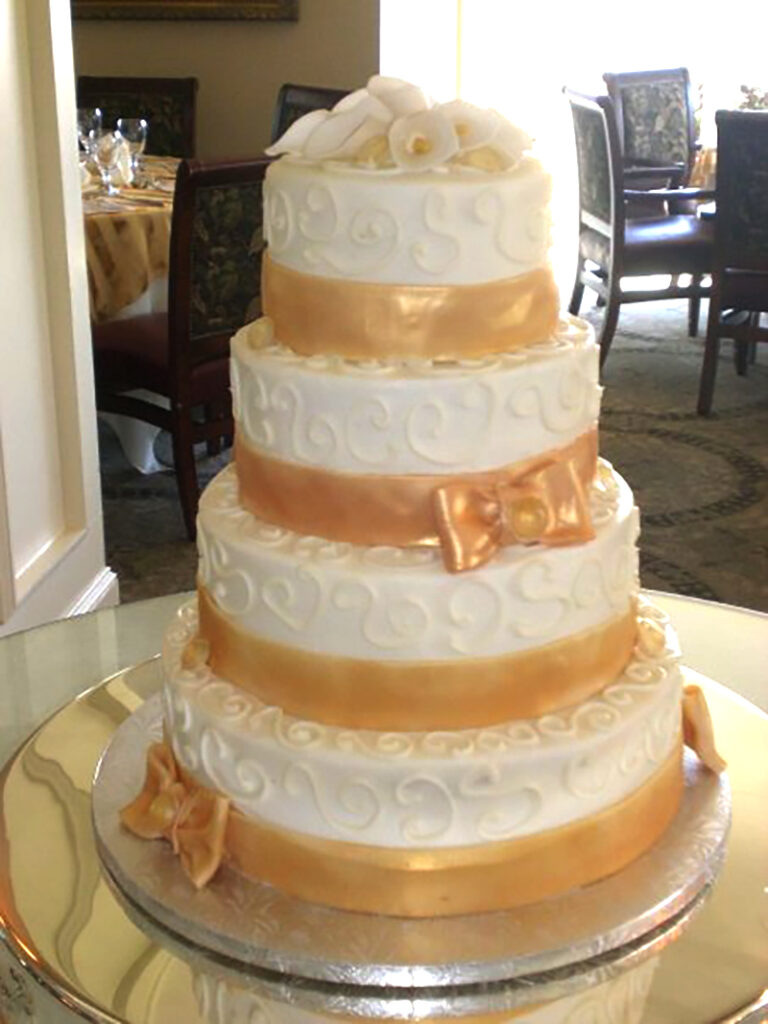 piped cake with gold bands wedding