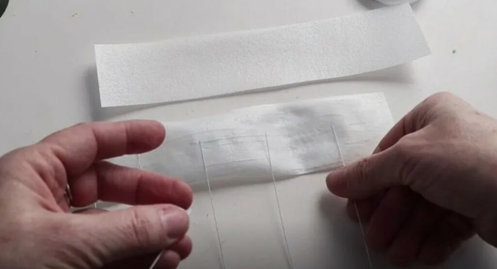 Gluing two strips of wafer paper together with wires in them.