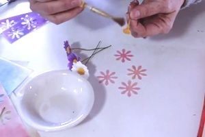 brushing gum glue on a wafer paper daisy