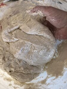 Stir more flour into the sponge mixture using your hand
