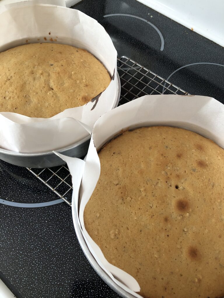 baked cake layers in pans with cake collars